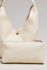 The Love Knot Slouchy Bag: Mini Buckle Edition by Anthropologie - Cream