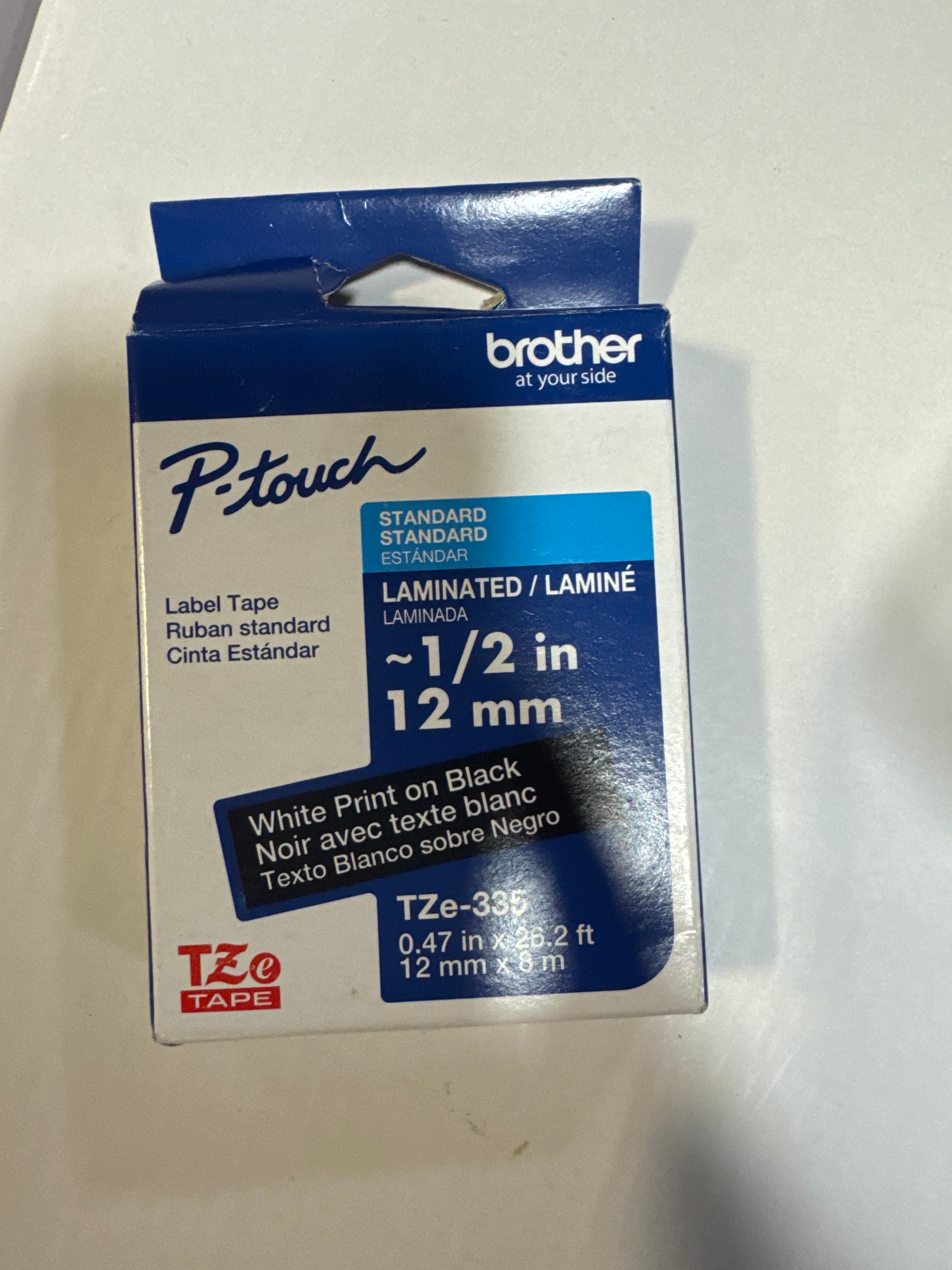 Brother P-touch TZe335, Laminated, 1/2" x 26.2 ft (12mm x 8m), White on Black Label Tape